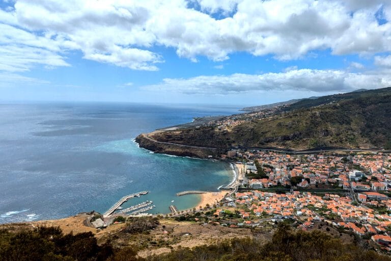 Autumn view from Pico do Facho with blue sky, Machico village, the ocean and the airport runway visible