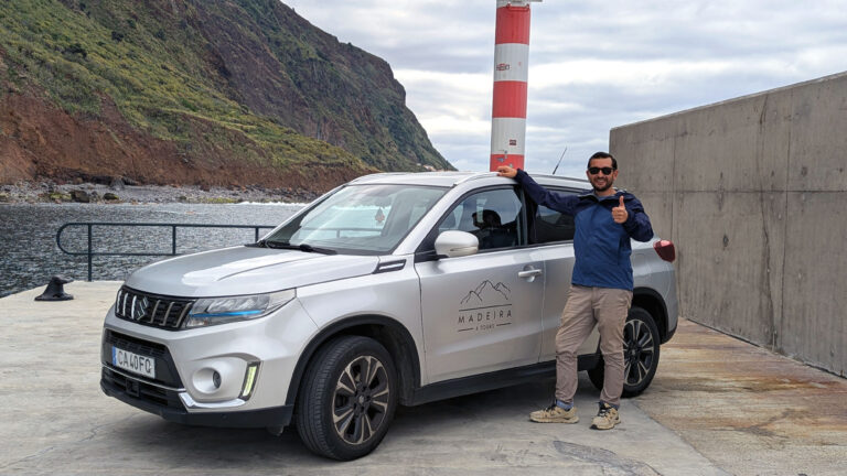 Ross standing beside the Suzuki Vitara Hybrid in Paul do Mar, giving a thumbs up